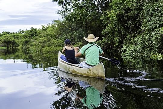 Couple riding canoe in Pantanal River, Brazil
