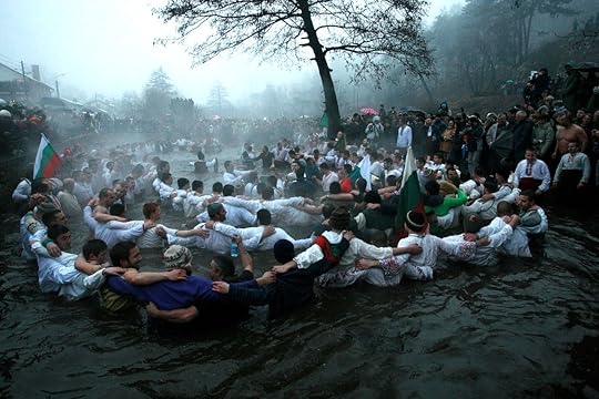 Men perform the national dance Horo in the icy waters of the river in Kalofer, Bulgaria for epiphany celebrations