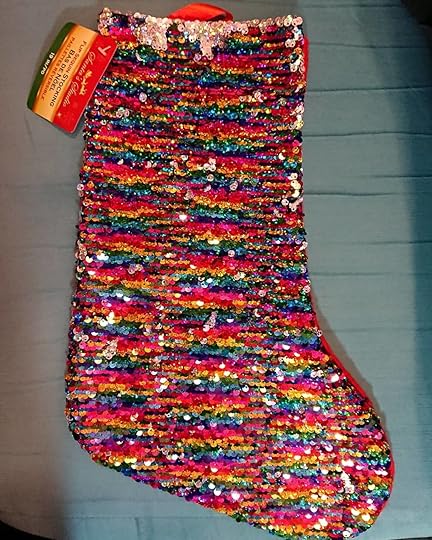 My neighbour and friend Debbie got me this awesome rainbow magic sequin stocking! Now I have that and a Wonder Woman one my dear friend Julie gave me. I love how we can find things for the holiday that fits what we love, is creative and playful, and isn’t just traditional.<br /><br />The lights on my tree and balcony look pretty and uplifting in the darkness, and Petal’s birthday also makes the season cheerier.<br /><br />What makes it cheerier for you?<br /><br />#cherylrainfield #YAwriter #LGBTQwriter #booknerd #bookworm #ireadYA #survivor #feminist
