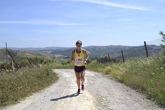 Woman running a marathon through the Italian countryside