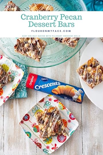 Cranberry Pecan Dessert Bars on a teal cake plate with individual holiday dessert plates.