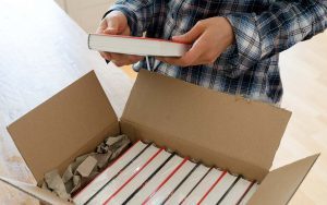 after learning how to publish a book an author opens package with samples of her work