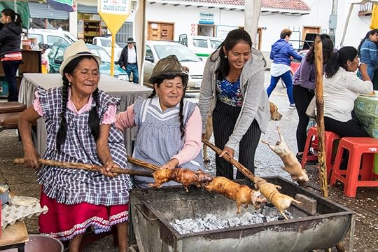 Peruvian women roasting guinea pigs on a spit