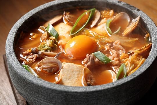 Korean soup with mushrooms, chives, and a raw egg yoke