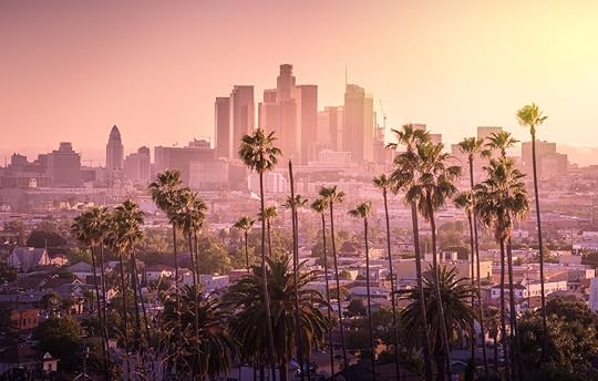 Beautiful Los Angeles sunset downtown skyline and palm trees in foreground