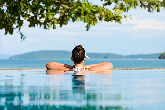 Woman with a flower in hair relaxing at the beach at Krabi, Thailand