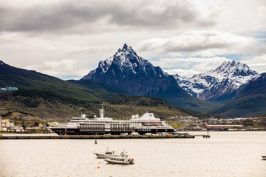 Antarctic cruise docked in front of mountains