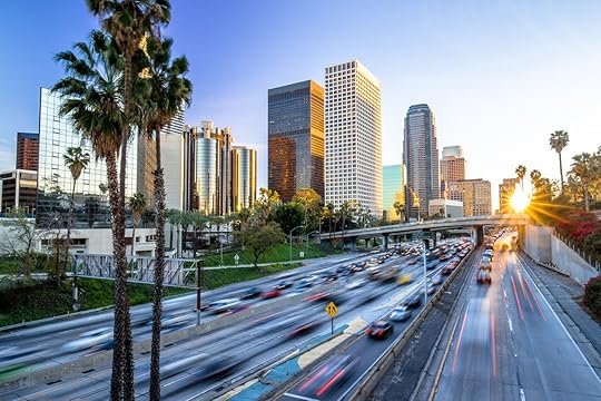 Los Angeles evening sunset highway traffic skyline buildings