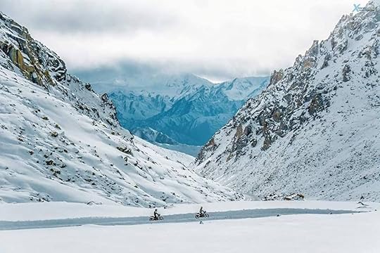 Ride The Himalayas motorcyclists driving through snowy mountains