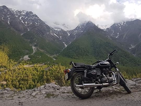 Ride The Himalayas motorcycle parked with mountains in the background