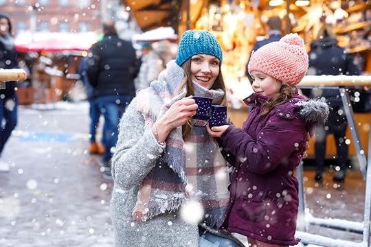 Adorable child and beautiful mum on Christmas market in Germany