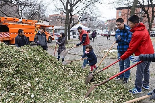 Group of people raking leaves