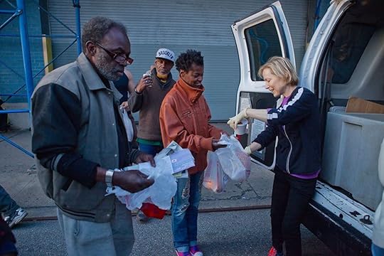 Volunteer handing out food to the homeless
