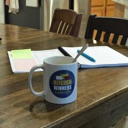 Kitchen Winners mug with meal planning notebook