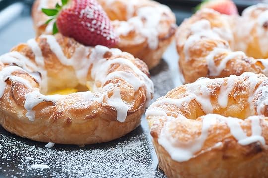 Danish pastries with white glaze and powdered sugar