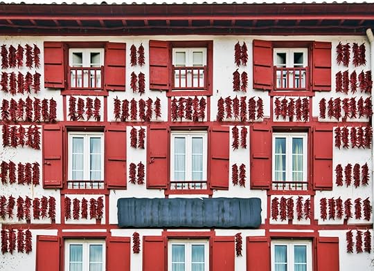Red Espelette peppers drying in the wall of a traditional Basque house in Espelette village, France