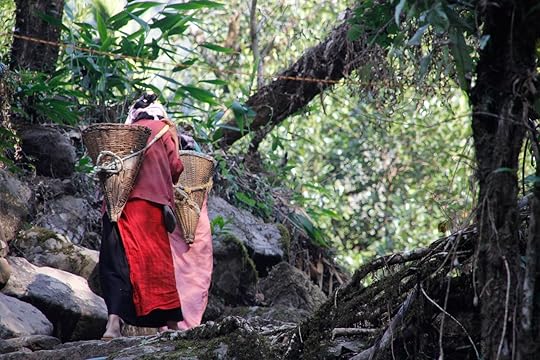 two unidentified women wearing traditional costumes are wearing a basketball on their backs in India