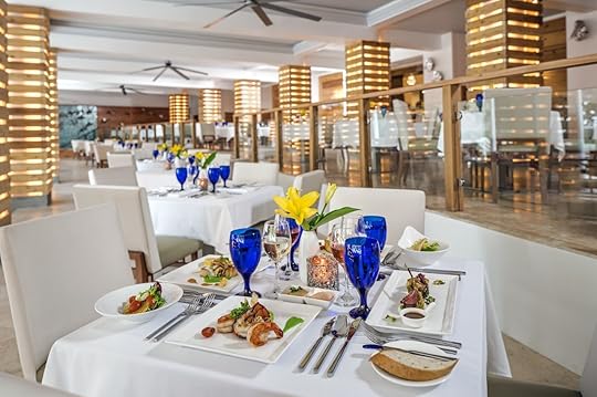 Dining room at a Sandals resort with meat and seafood dishes on the taable