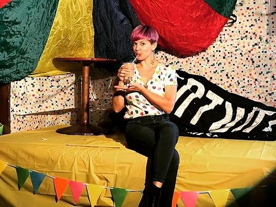 The STUD LGBTQ colorful decor with a girl drinking a cocktail