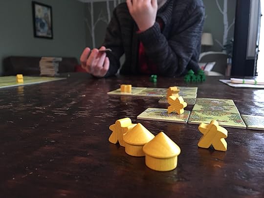 Little boy playing Carcassonne