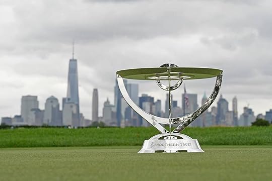 The Northern Trust trophy on a green with the city skyline in the background