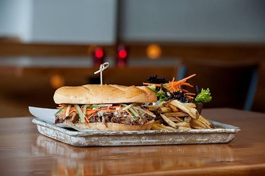 Pork and veggie sandwich with a side salad and fries