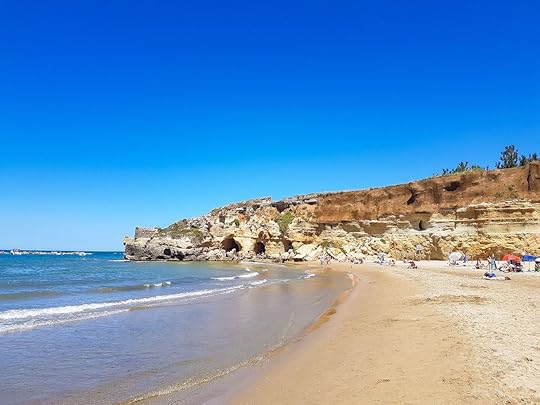 The beach at Grotte di Nerone with people and sea