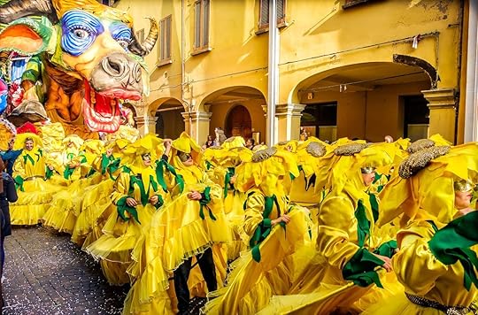 Carnevale di Cento paper cow coward parade float with people choreography in yellow sunflower costumes