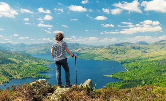 Hiking woman on top of the Mountain in Ben A'an Hill, Highlands, Scotland
