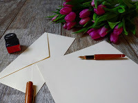 Picture of pen, paper, envelopes and ink bottle, for letter writing