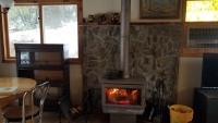 Cabin with fire burning in stove.