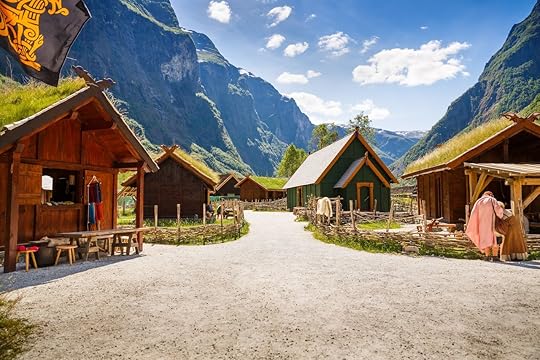 Traditional wooden houses and people in viking village museum