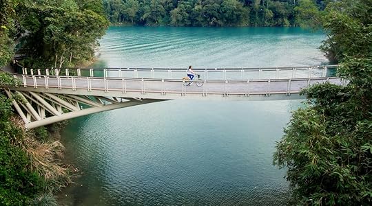 Young girl riding bicycle on the bridge at Sun Moon Lake, Nantou, Taiwan
