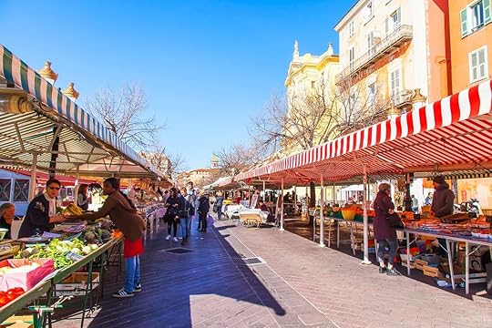 Various vegetables and fruit are laid out on counters of the well-known Cours Saleya market in Nice, France