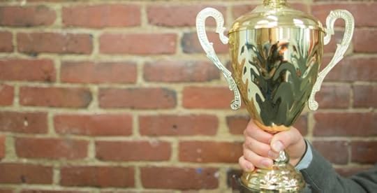 Business man holding trophy to celebrate win