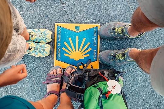 Three peers piligrims feet on the start of the Camino de Santiago