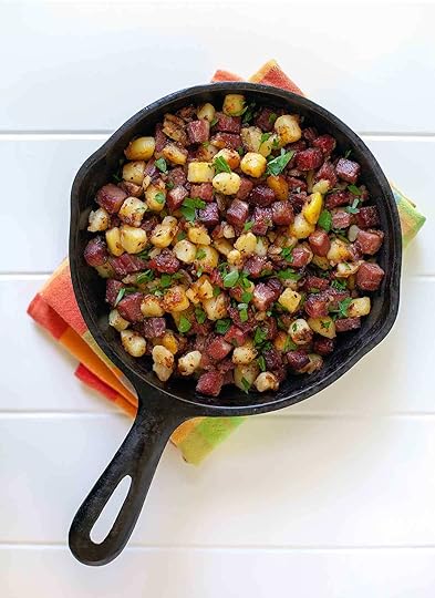 A small skillet full with corned beef hash on a dish towel
