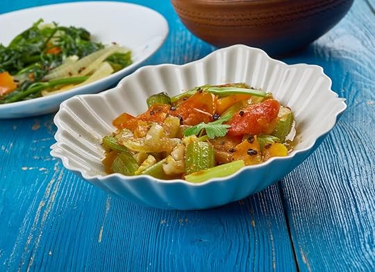 vegetable stew from chad in a white bowl on a blue wooden table