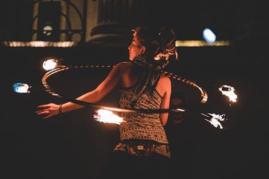 Woman juggling fire with hula-hoop