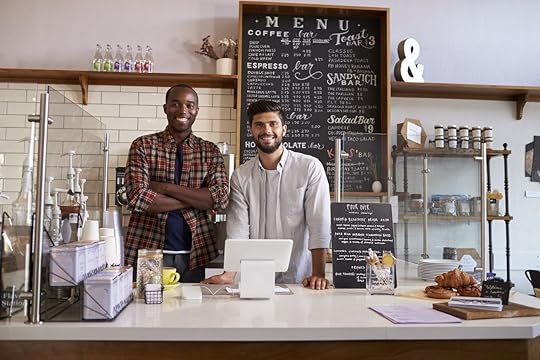 Business partners stand behind the counter at a coffee shop