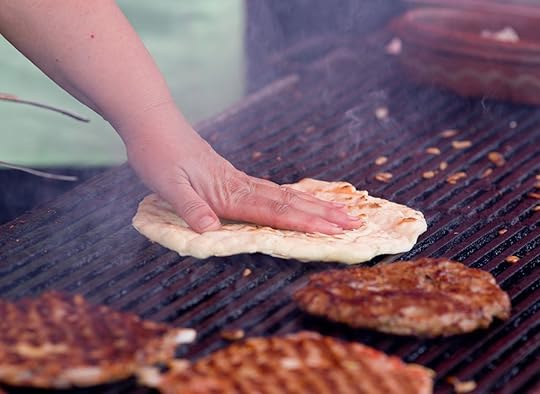 Close up of traditional Balkan food, burgers and flat bread on barbecue