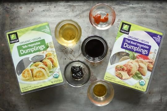 Two packages of Nasoya dumplings and individual ramekins of dumpling sauce ingredients.