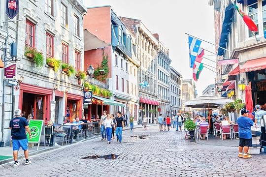 People at the junction of St. Paul Street and St. Vincent Street in the Old Montreal section of Montreal