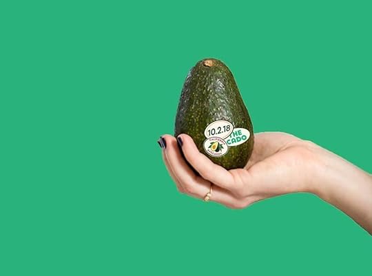 Hand holding an avocado