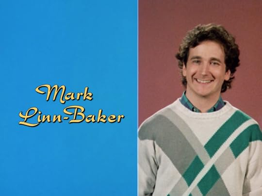 Mark Linn-Baker in the same type of set up, but instead of his original sweater, he's in a way more '80s one with diagonal, intersecting slashes of green and gray.