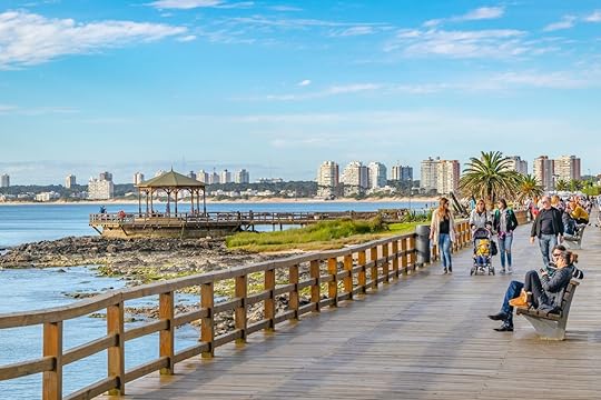 People at sunny winter at waterfront boardwalk in Punta del Este city, Uruguay