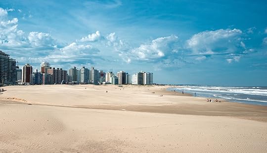 Wide sandy stretch of Uruguay coast ringed by skyscrapers