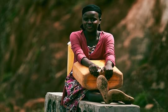 Portrait of a woman from Rwanda in a pink dress