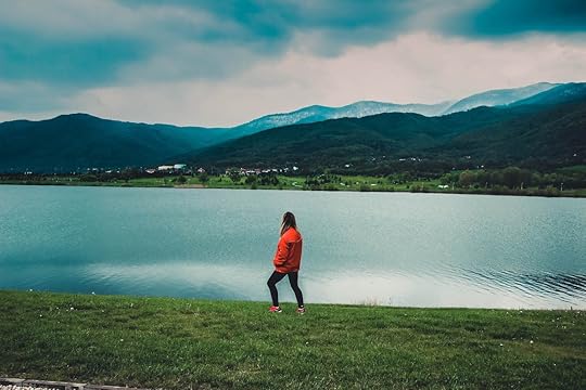 Solo female traveler against mountain landscape