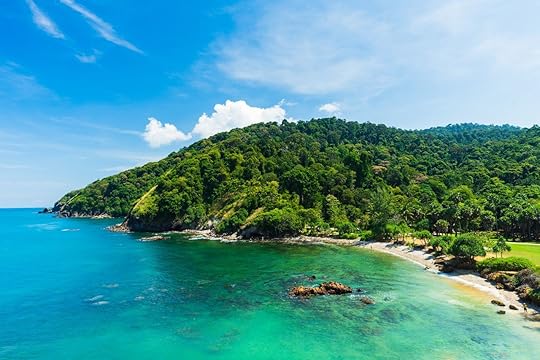 Summer beach with clear sea, green forest and blue sky on Koh Lanta island in Thailand